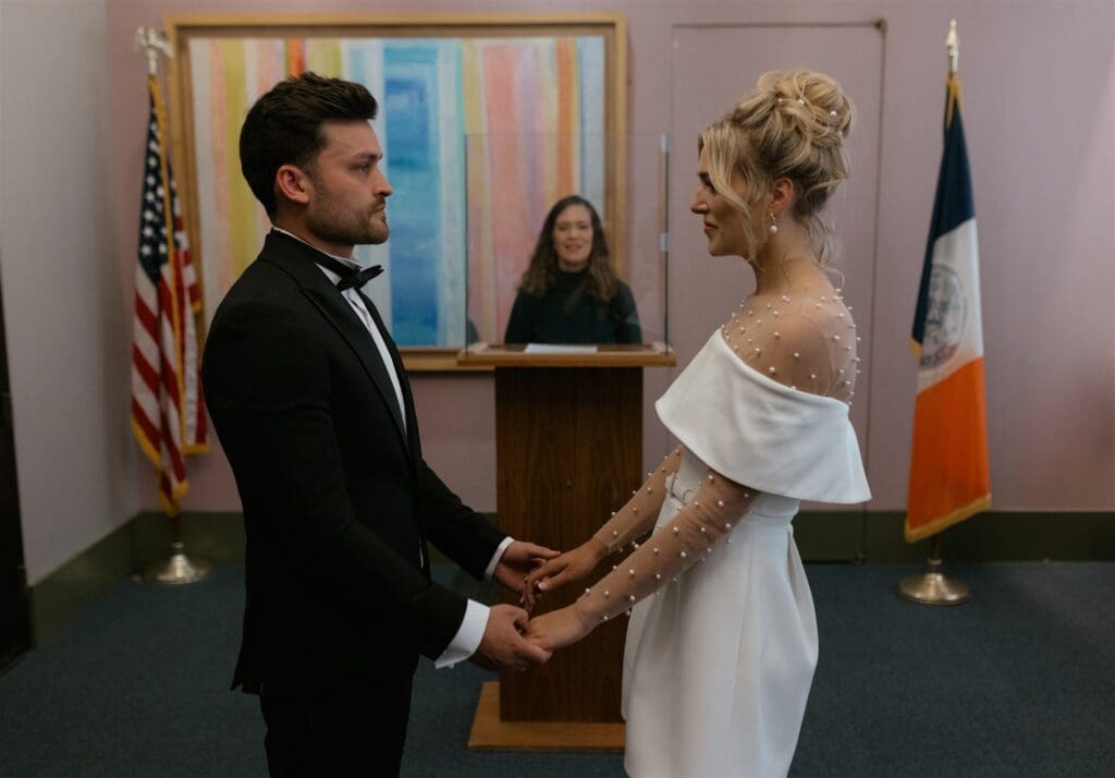 cute picture of the bride and groom holding hands at their dream elopement in NYC