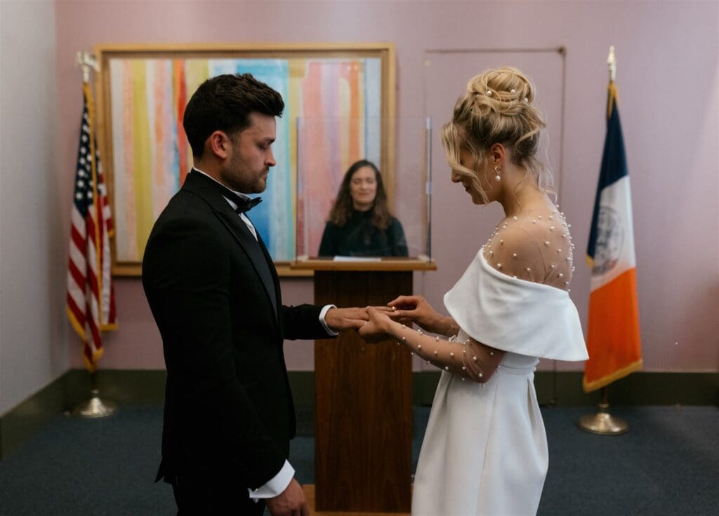 happy couple exchanging rings at their ceremony