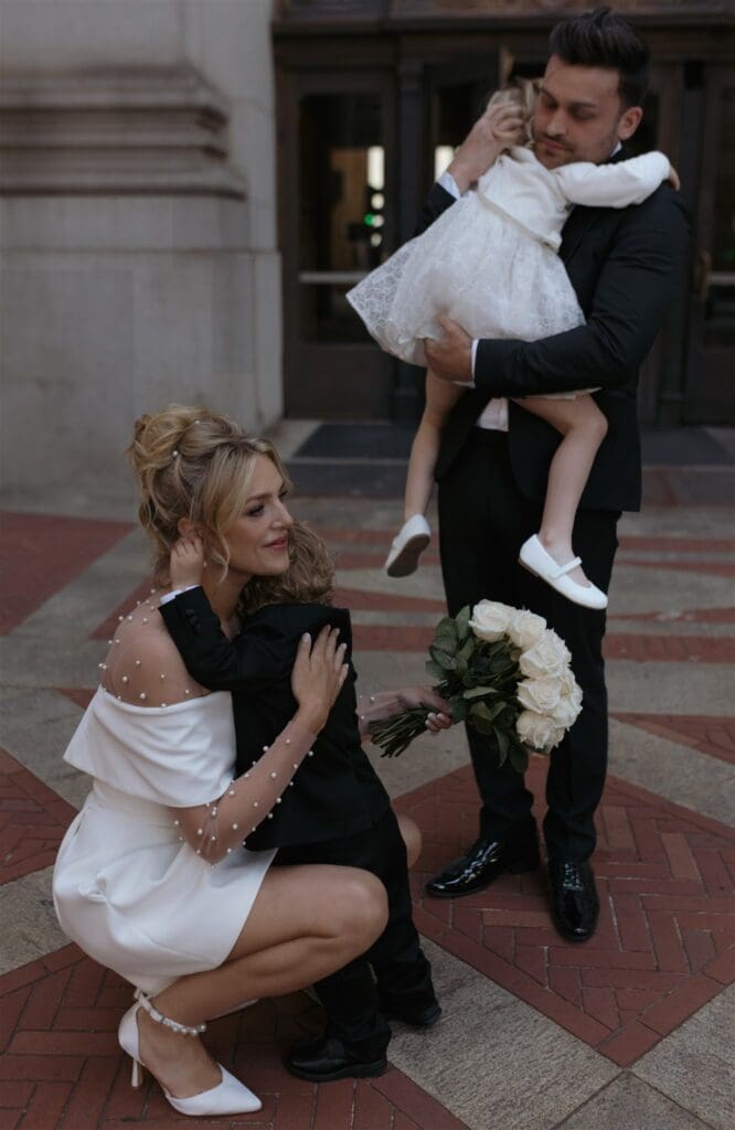 cute picture of the newlyweds hugging their children during their photoshoot