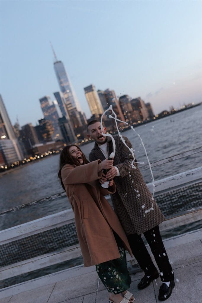 couple celebrating their engagement with champagne