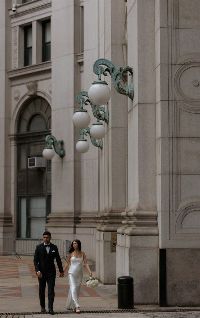 couple walking around NYC before their elopement ceremony