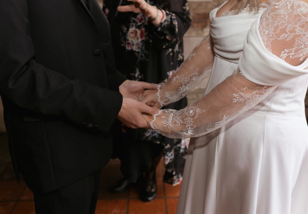 bride and groom holding hands during their ceremony