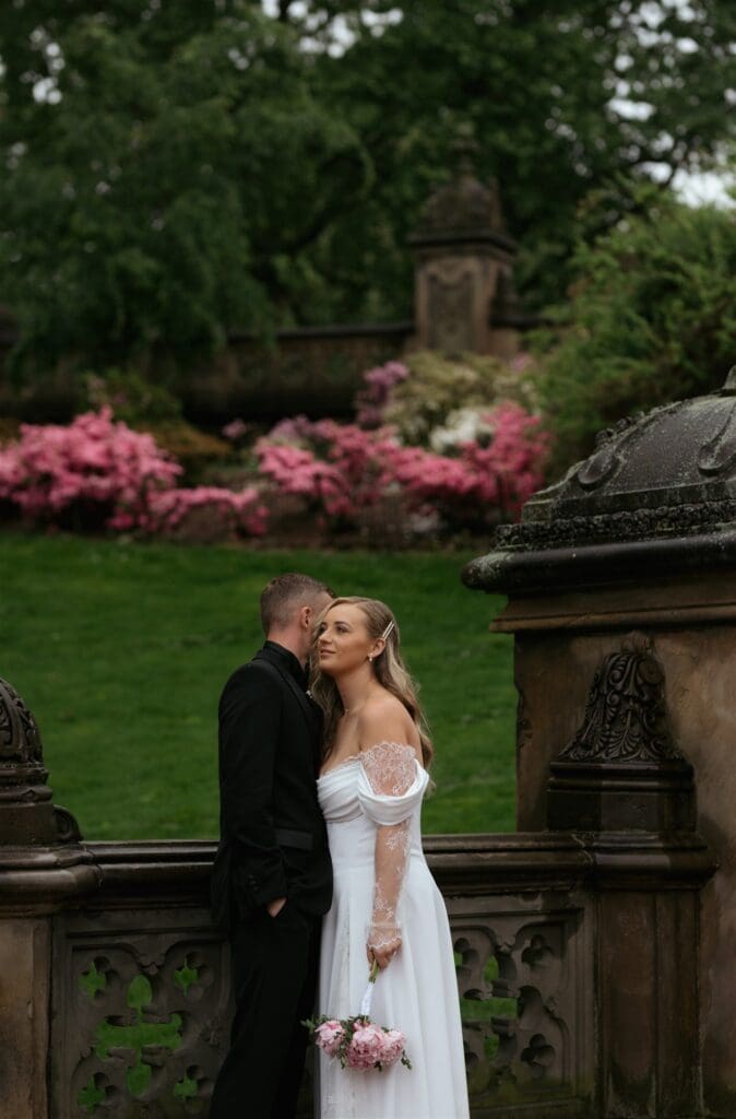 portrait of the groom kissing the bride on the cheek
