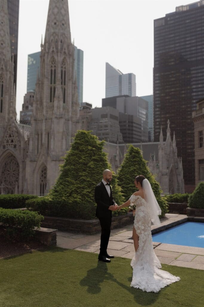 cute picture of the b ride and groom holding hands during their first look