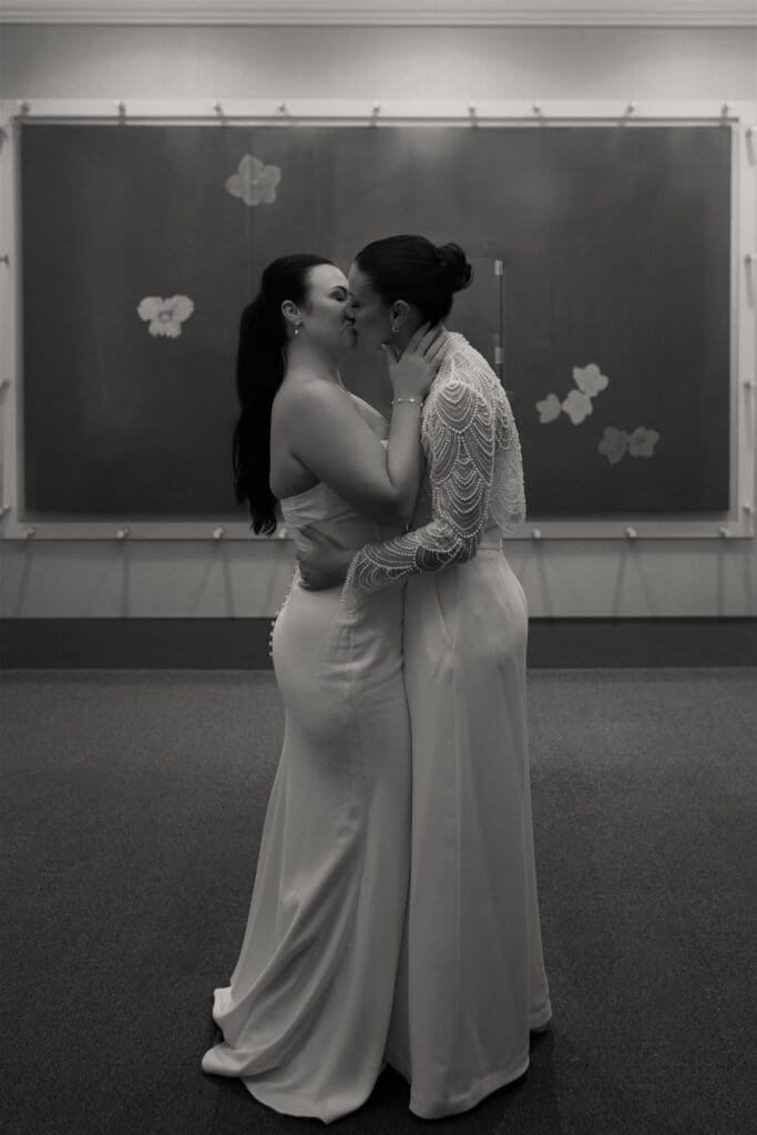 Brides kissing after their ceremony