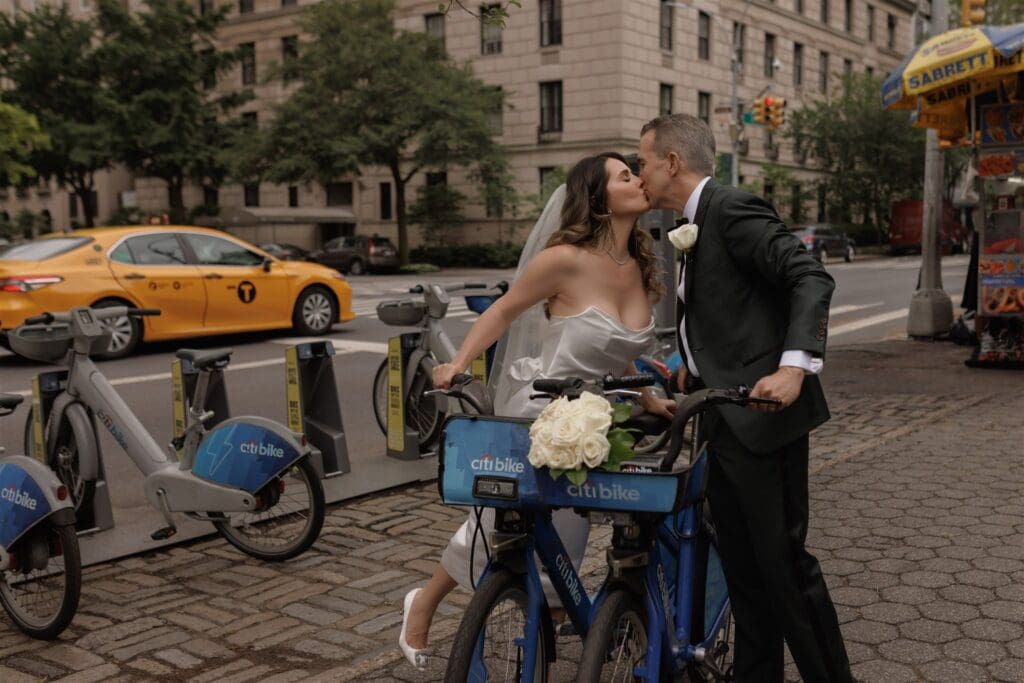 cute couple riding bikes after their ceremony