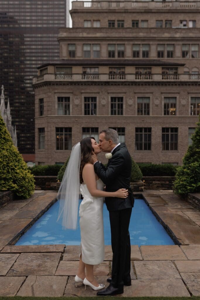 portrait of the bride and groom kissing after their ceremony