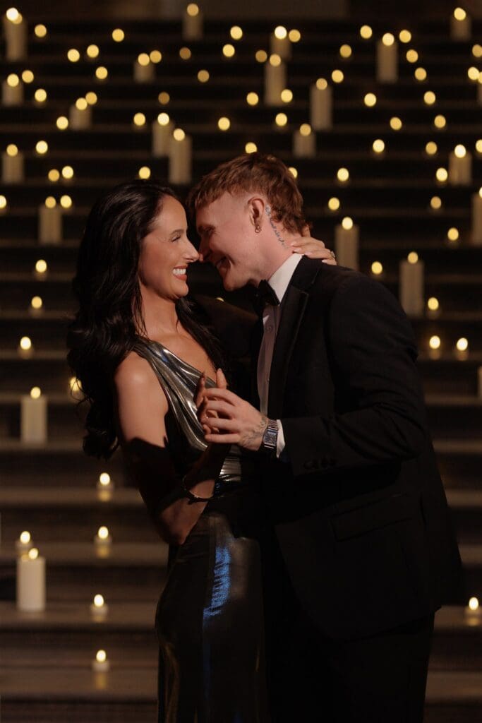 Cute picture of the newly engaged couple smiling at each other