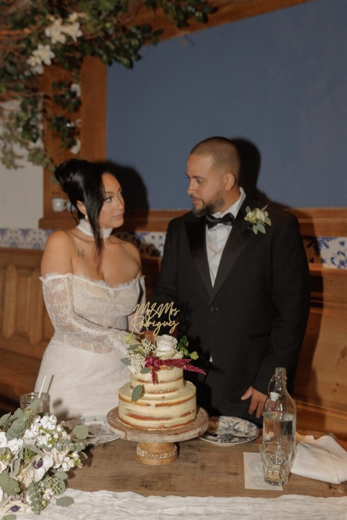 cute picture of the newlyweds cutting their wedding cake
