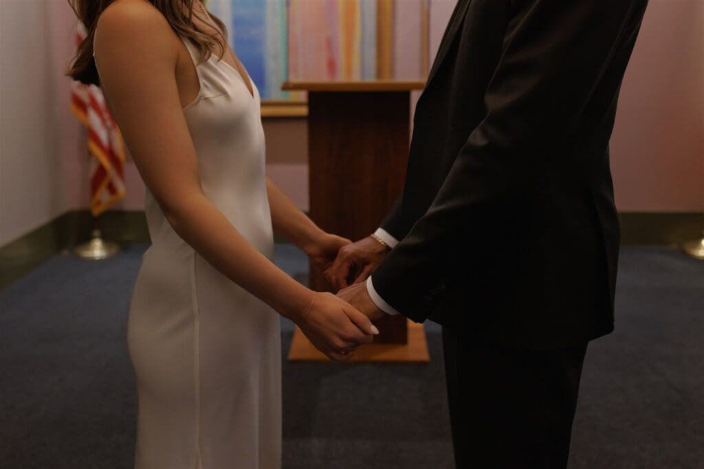 couple holding hands during their wedding ceremony