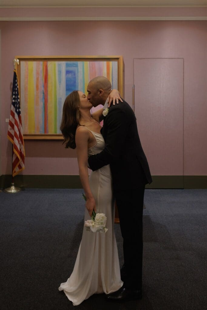 cute picture of the bride and groom kissing after their ceremony