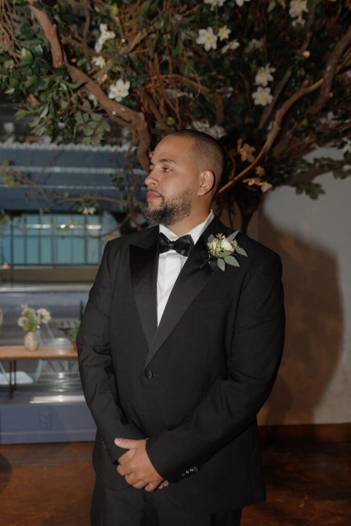 groom watching the bride walk down the aisle