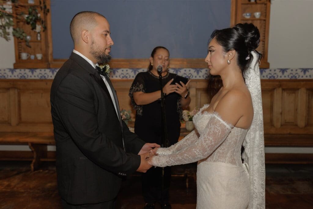 bride and groom holding hands during their ceremony
