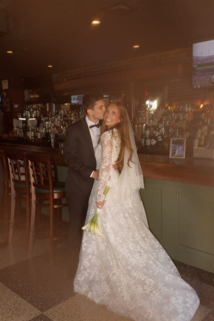 groom kissing the bride on the cheek