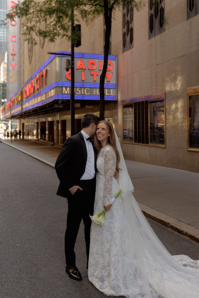 groom kissing the bride on the cheek